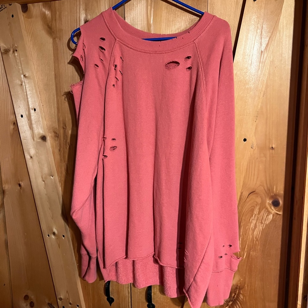 Pink ripped sweater.